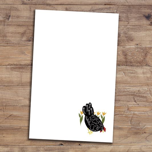 Floral chicken notepad on wood background