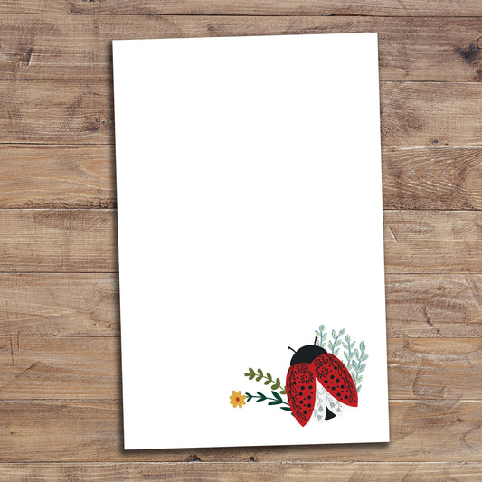Floral Ladybug notepad on wood background