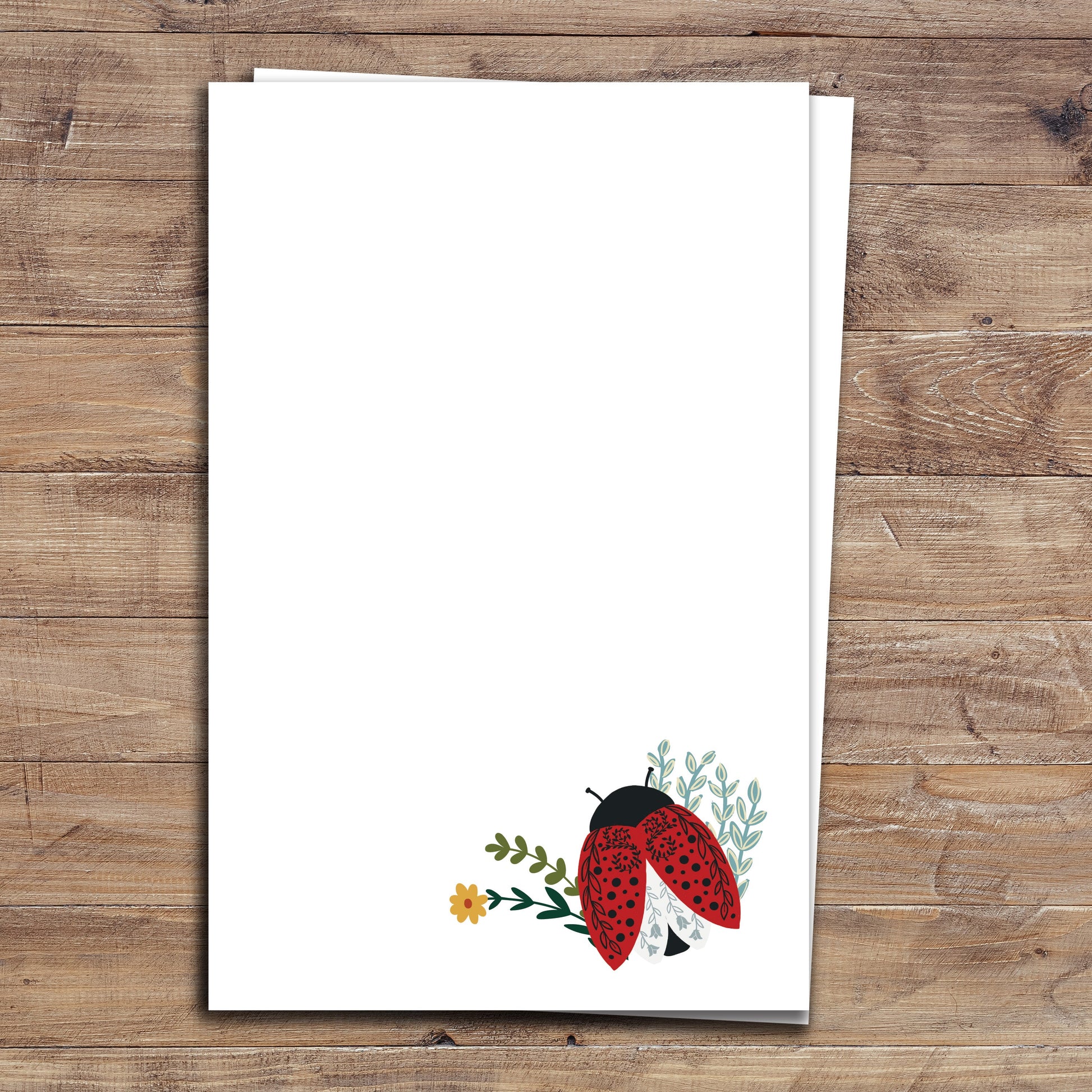 Two Floral Ladybug notepads on wood background