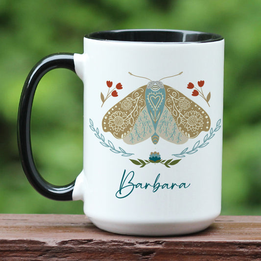 Boho floral moth mug personalized with name. The mug has a black handle.