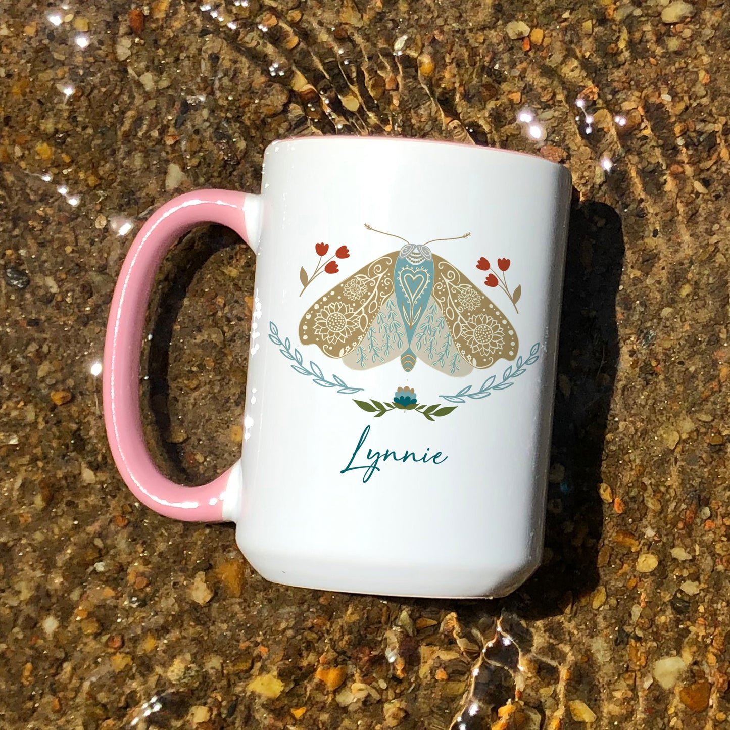 Boho floral moth mug personalized with name. The mug has a pink handle.