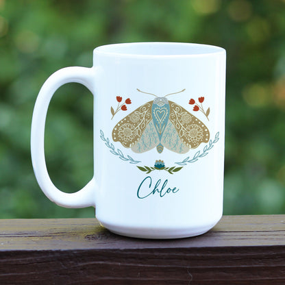 Boho floral moth mug personalized with name. The mug has a white handle.