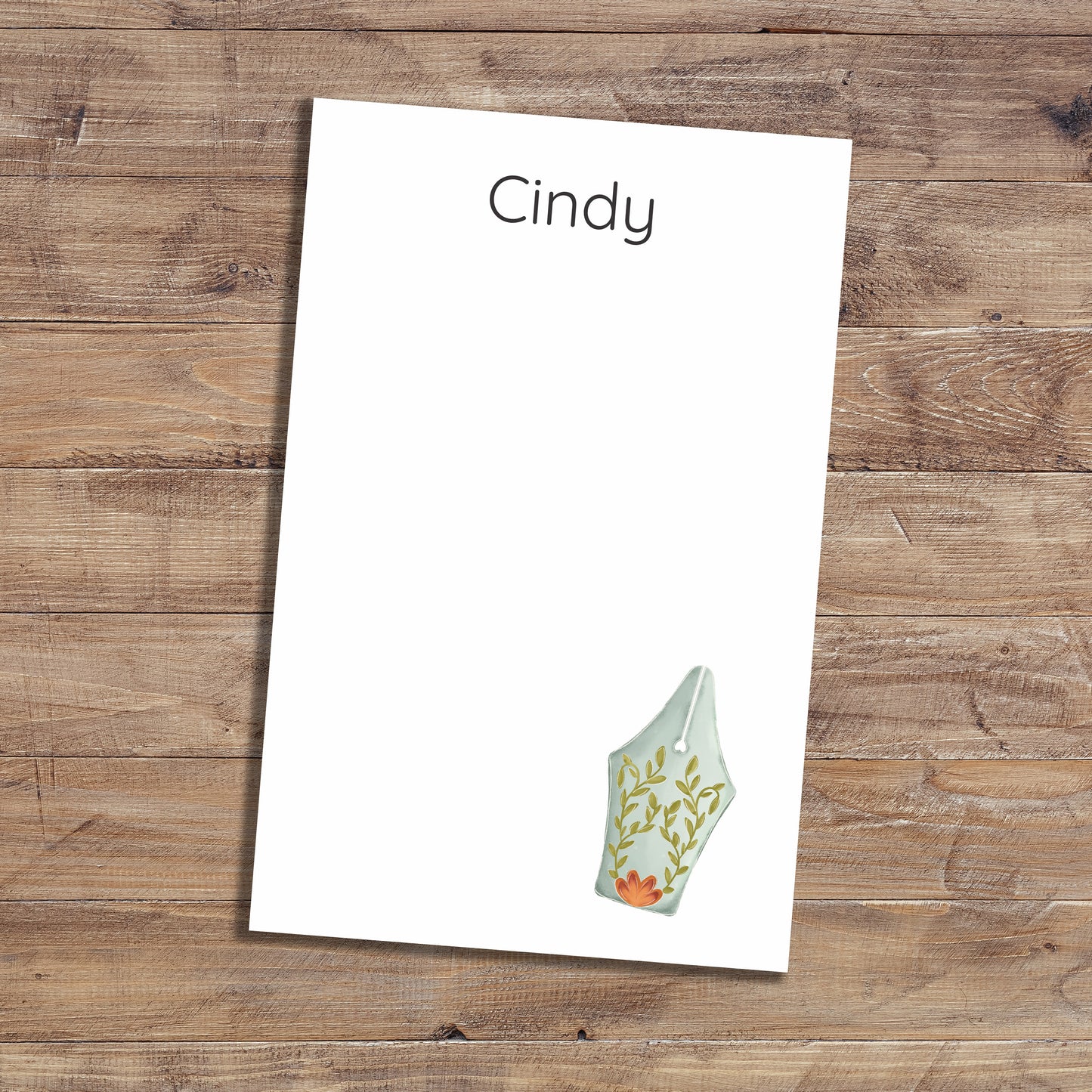 Personalized notepad with fountain pen and floral garden design.