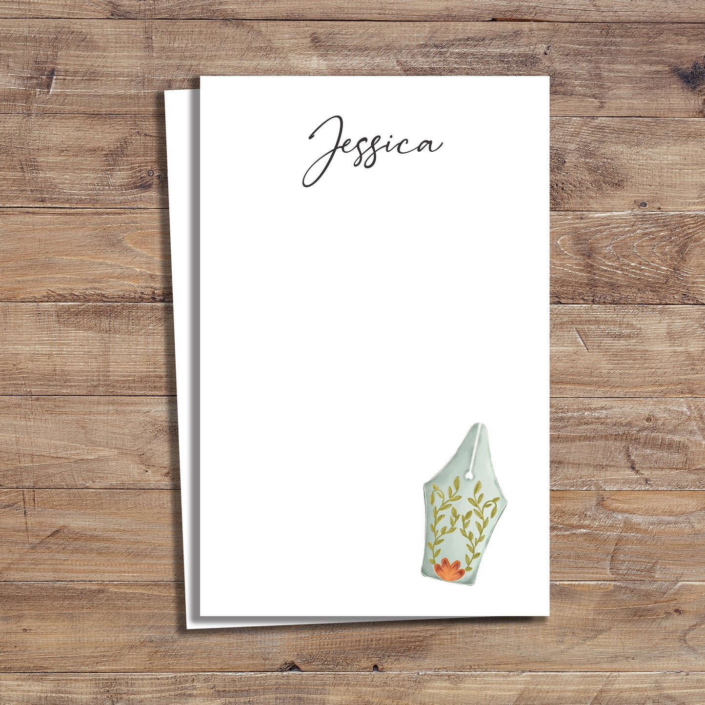 Personalized notepad with fountain pen and floral garden design.