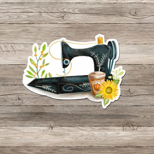 Antique sewing machine with fall sunflower PSL sticker on gray wood background.