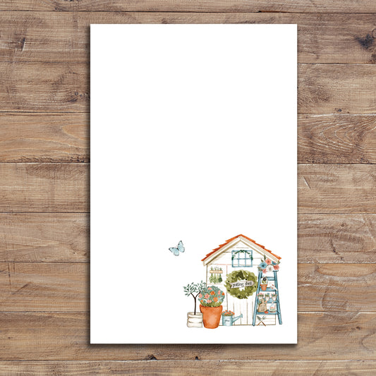 Garden shed notepad on wood background