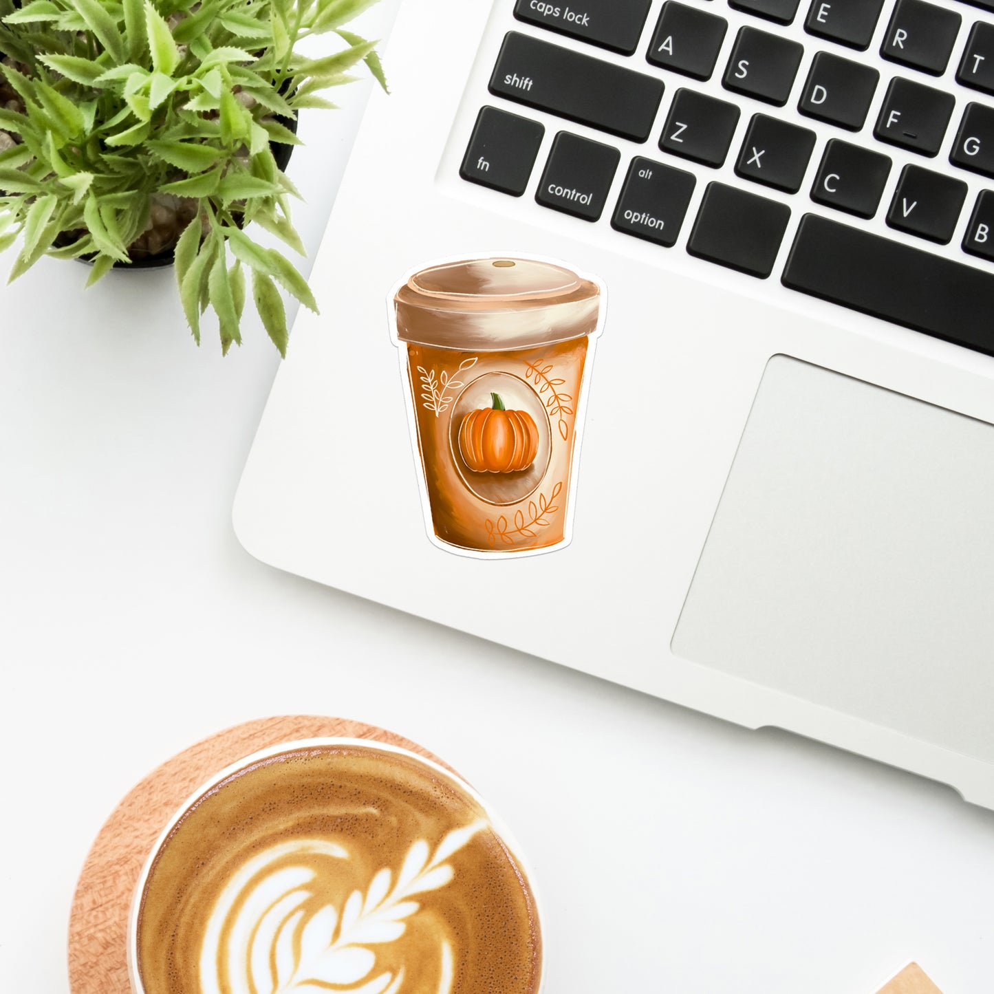 Pumpkin Spice Latte Fall Coffee Cup UV Vinyl Sticker on laptop with plant and coffee.