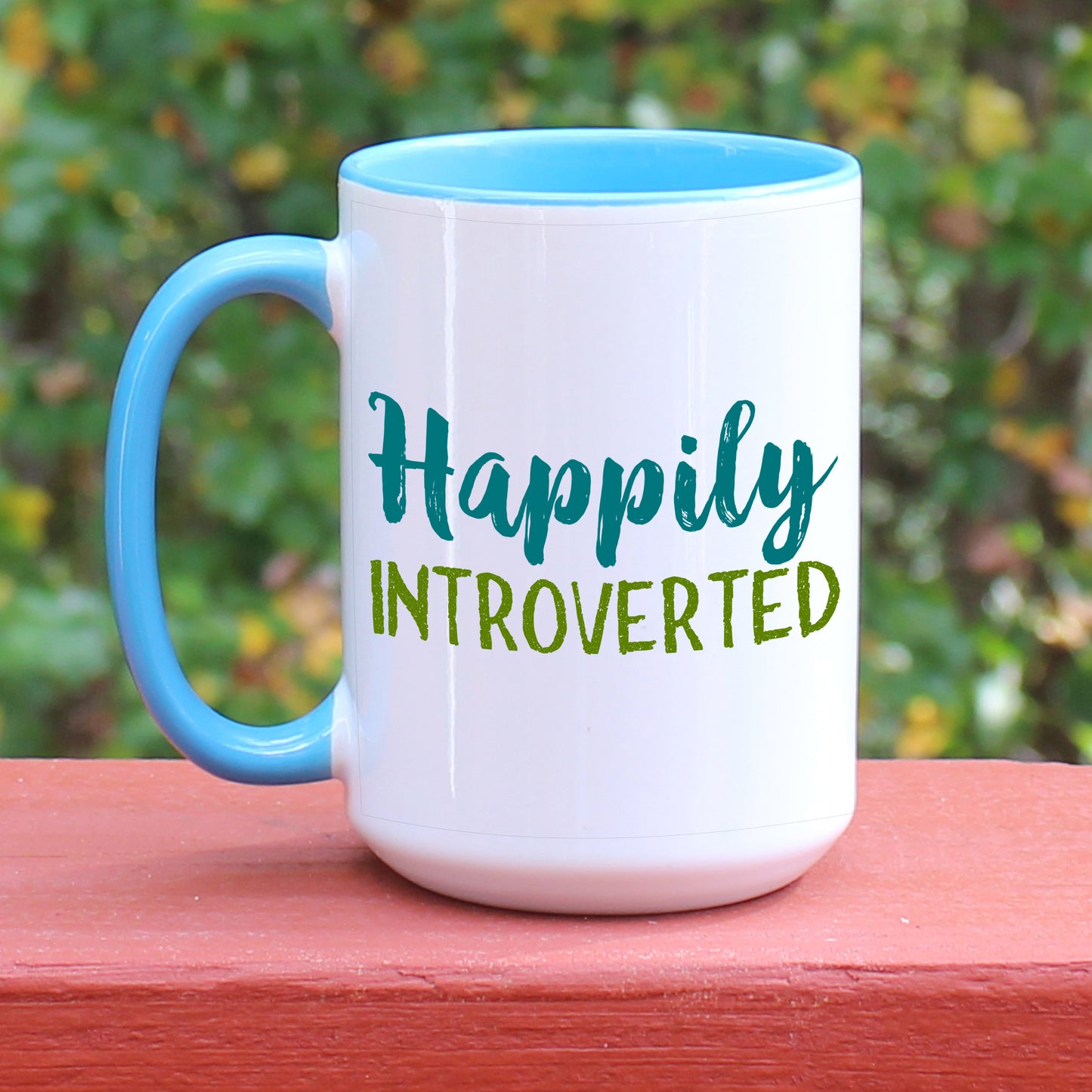 Happily Introverted ceramic coffee mug with blue handle
