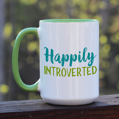Happily Introverted ceramic coffee mug with green handle