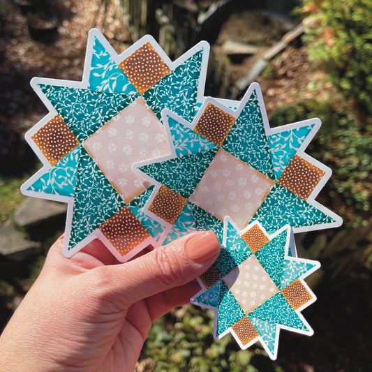 Blue and Brown Quilt Block Stickers in small, medium and large held against outside background