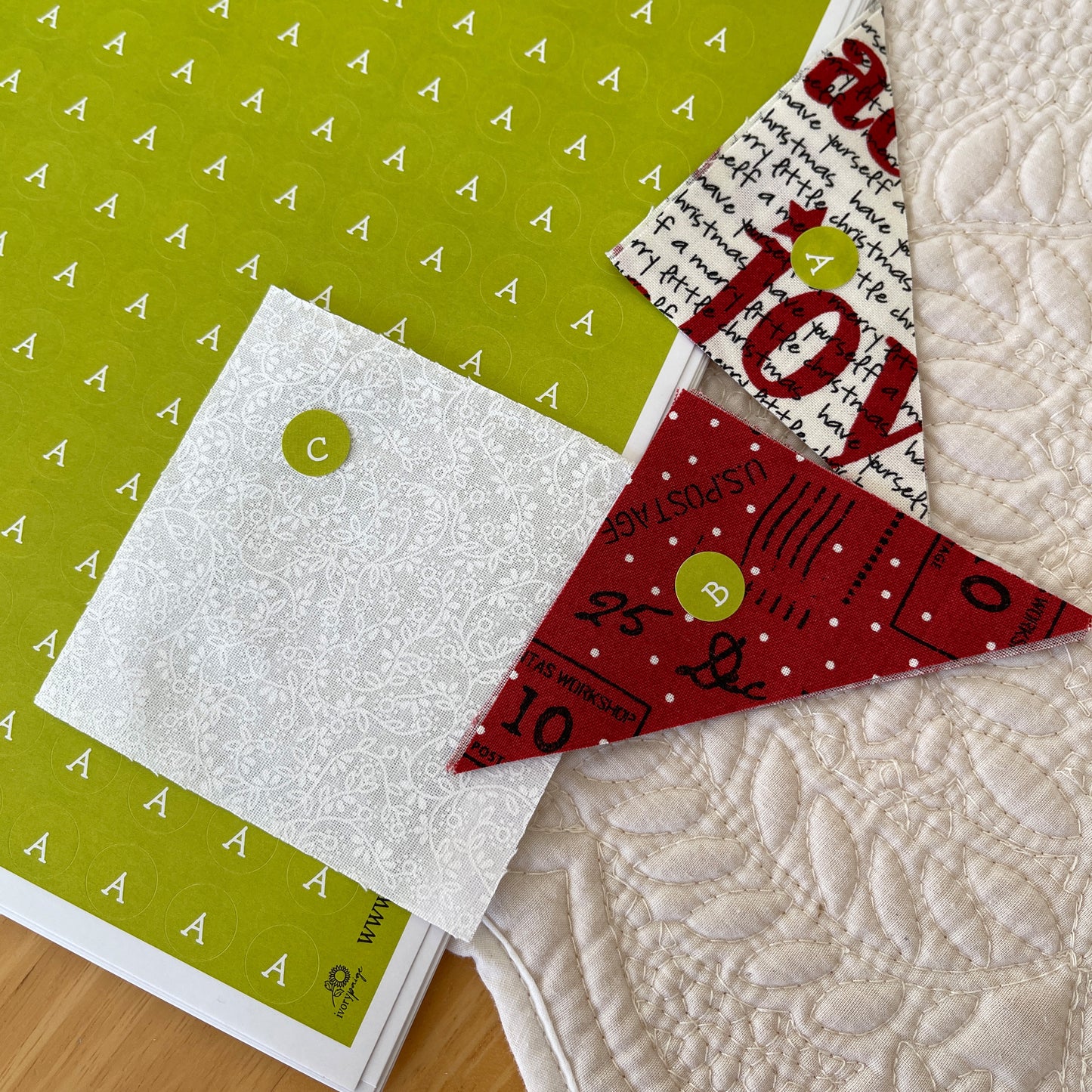 Green letter stickers for quilt sewing pieces on fabric