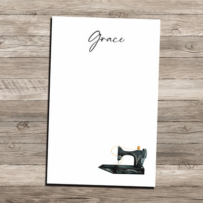 Antique sewing machine personalized notepad on wood background.