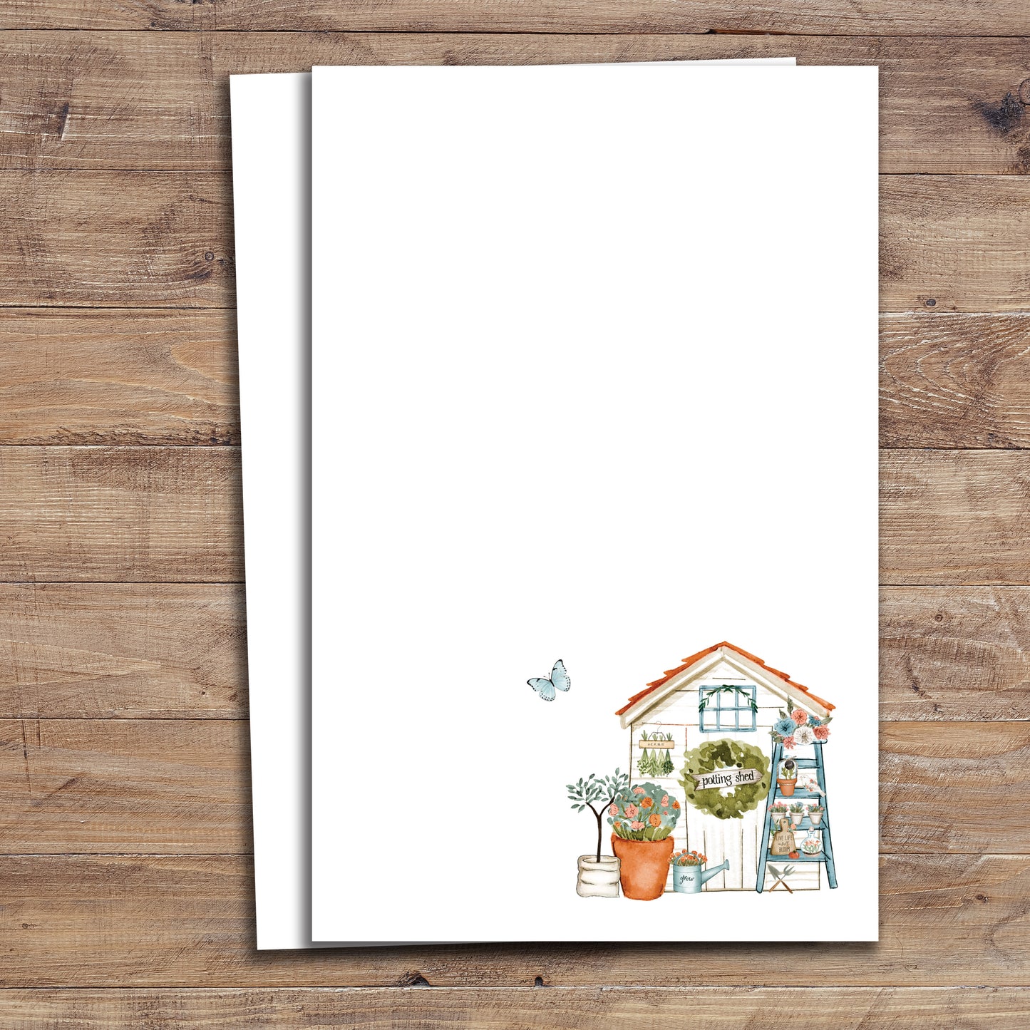 Two Garden shed notepads on wood background.