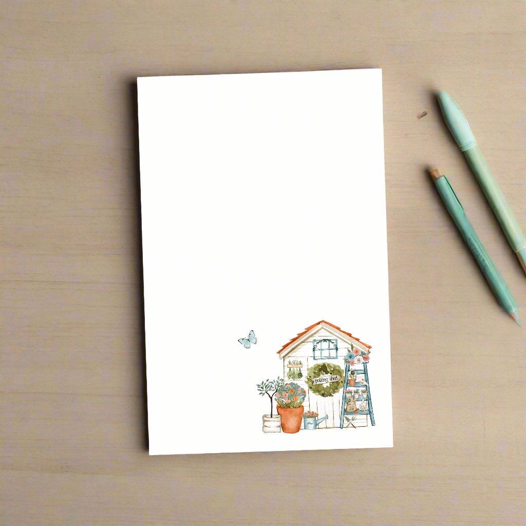 Garden shed notepad on wood background