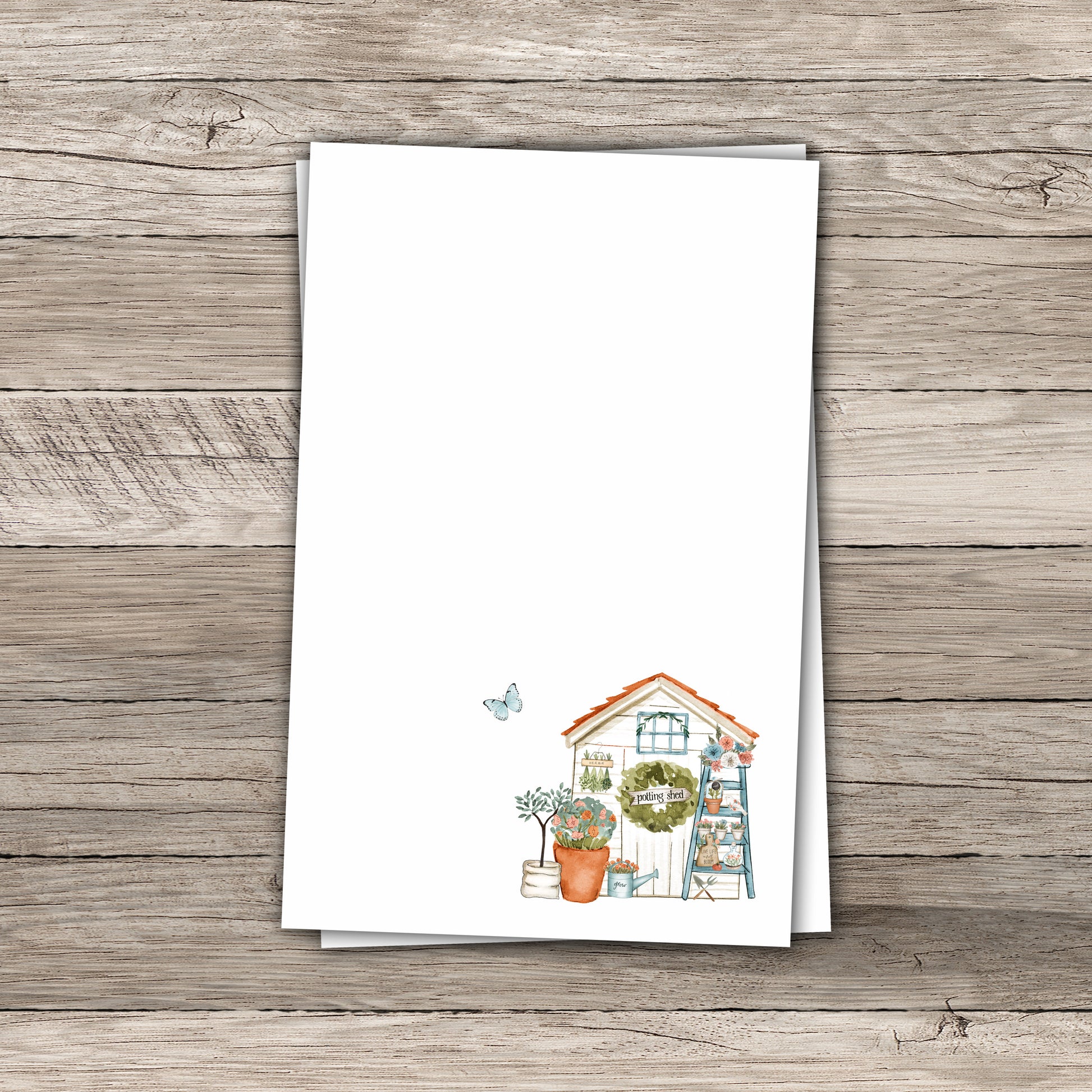 Garden shed notepad on wood background