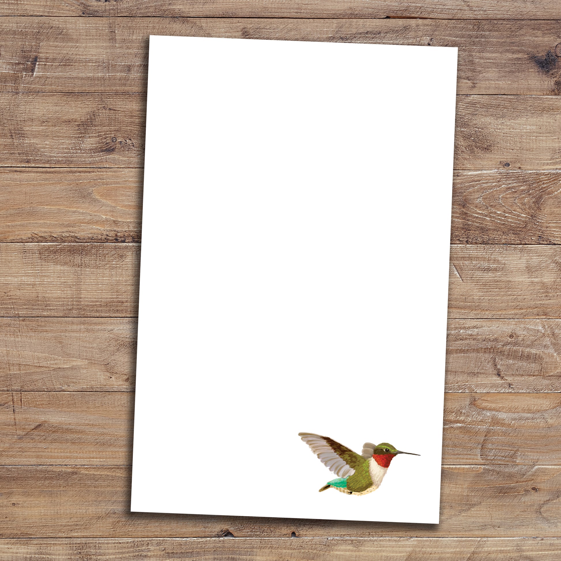 Hummingbird notepad on wood background