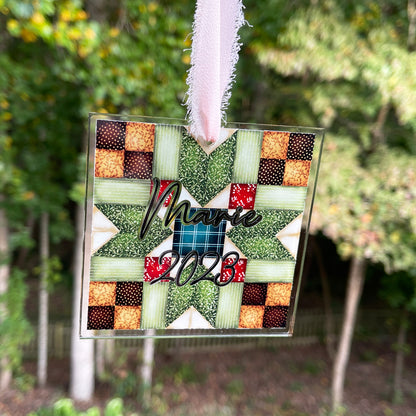 Personalized quilt block Christmas ornament with chiffon ribbon. Blue, red, greens,and browns.