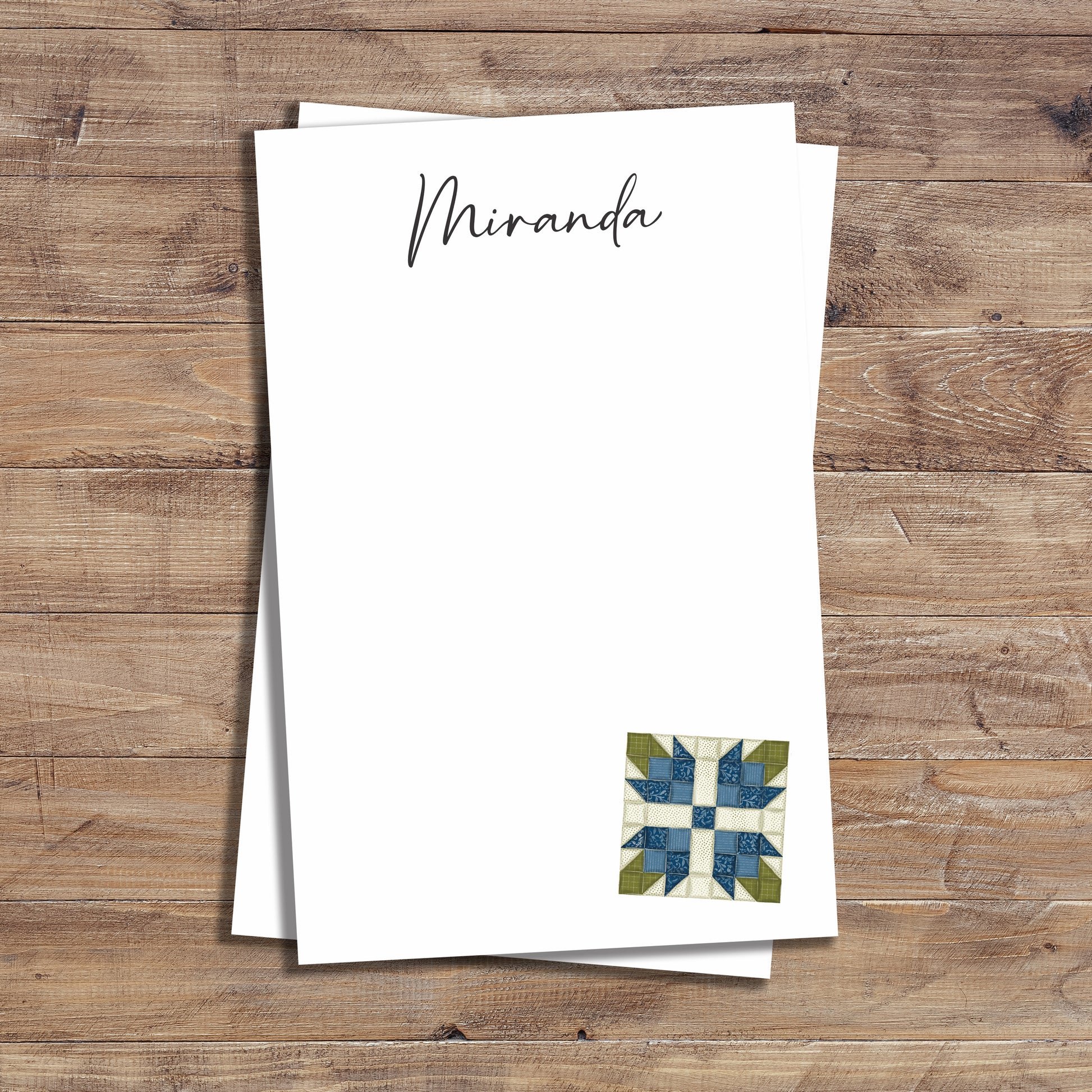 Personalized notepad with blue tea rose quilt block design.