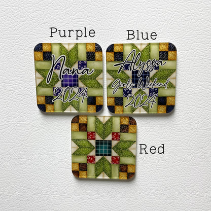 Three square acrylic magnets with quilt patterns and personalized text. The top left magnet says 'Nana 2024,' the top right says 'Alyssa Girls Weekend 2024,' and the bottom magnet features a green and red quilt design without text.