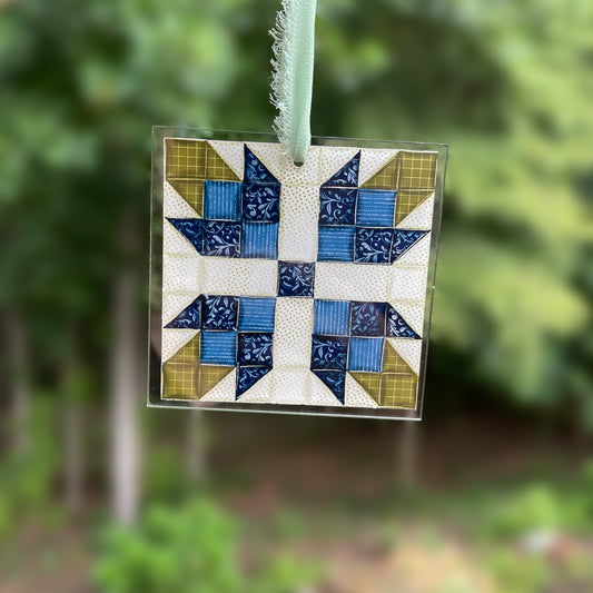 Blue Quilt block flower ornament with blurred background 