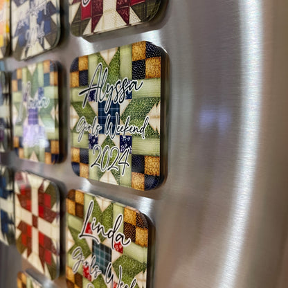 Side view of several square magnets with quilt patterns attached to a metallic surface. The front magnet features a design with green, red, and beige colors and is personalized with the text "Alyssa Girls Weekend 2024."