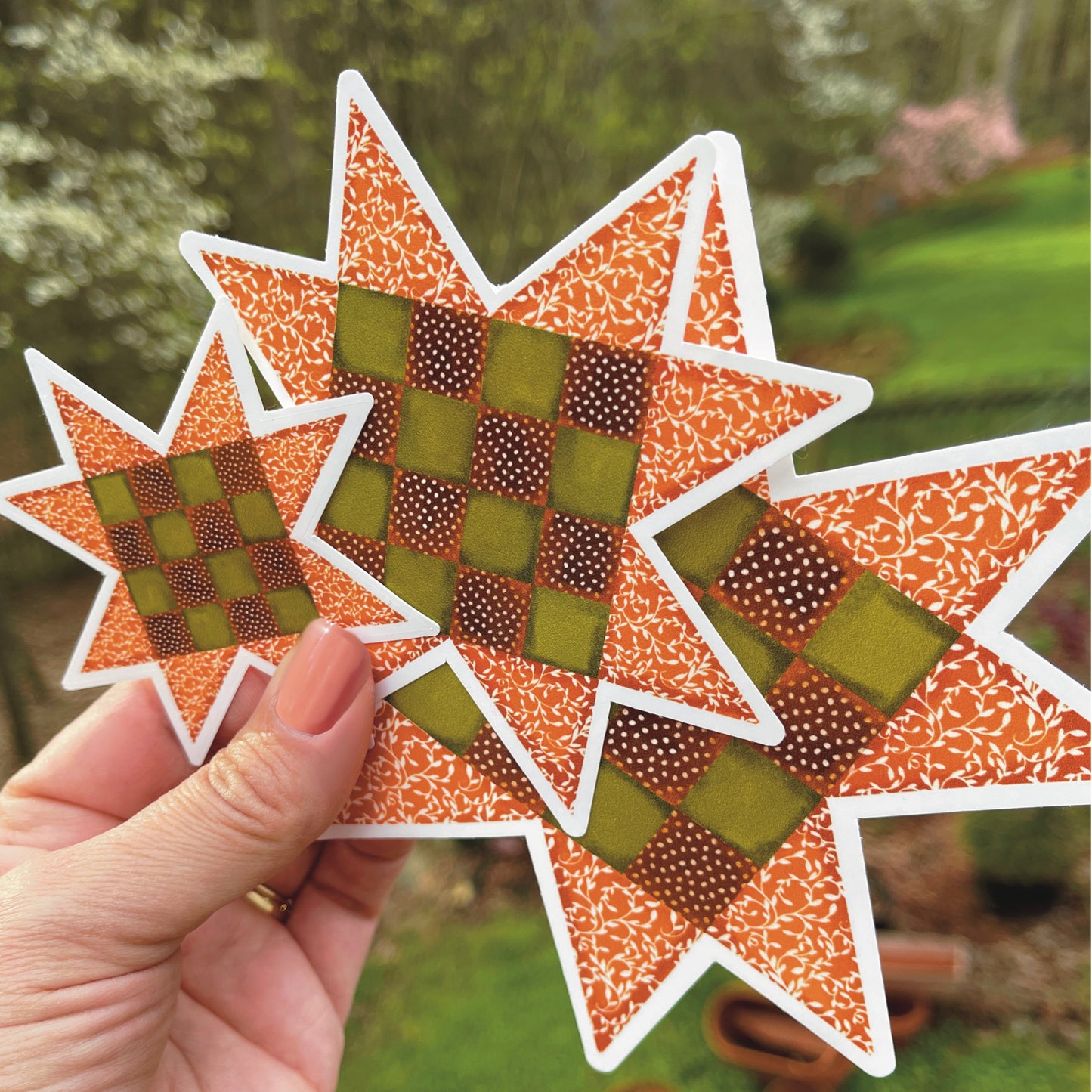 Three sizes of Sawtooth Star Quilt Block Sticker in Fall Orange and Brown 